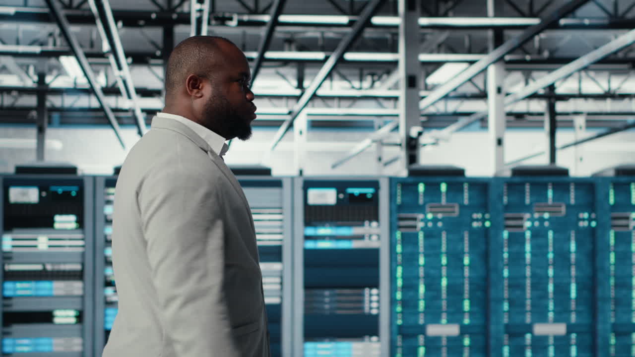 Vertical video System administrator walking in data center with rigs doing backups