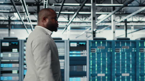 vertical video system administrator walking in data center with rigs doing backups