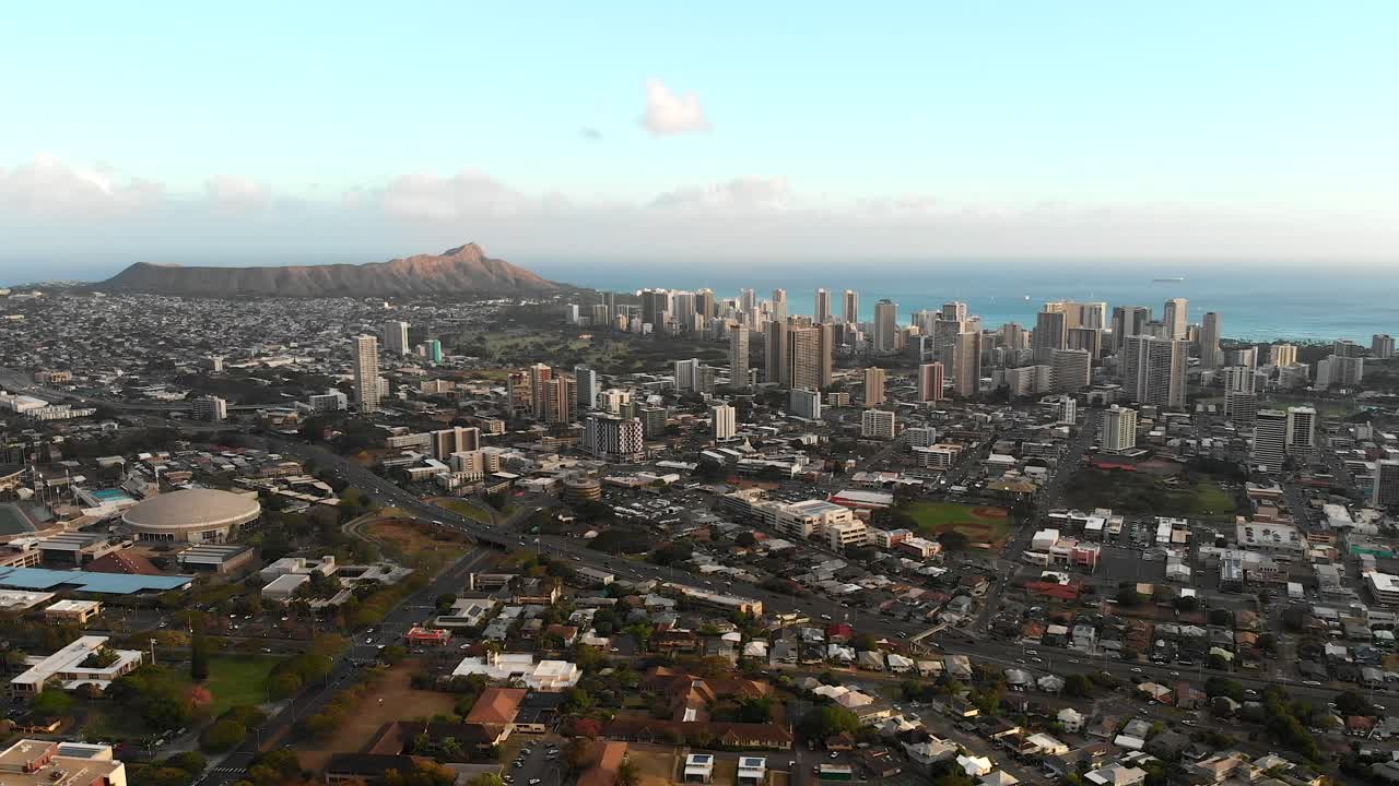 Stationary Aerial over Resedential Area in Honolulu, with Cars and Traffic. Waikiki Beach and Diamond Head in the background.