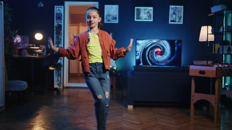 happy child in apartment illuminated by rbg lights filming dance tutorial for other children