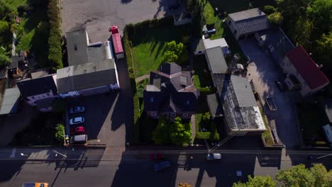 drone-shot-tilt-up-of-small-town-with-sunrise-in-the-morning-in-summer