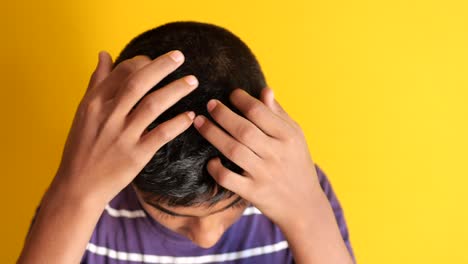 boy scratching his head