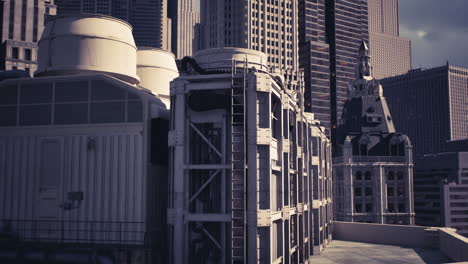 view of modern rooftop equipment against a backdrop of city skyscrapers