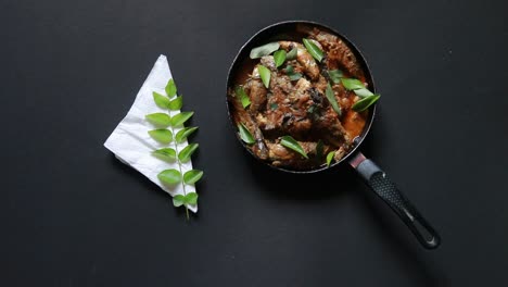 fish-curry-on-black-background