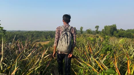 Young-man-walking-in-beautiful-hilly-landscape-during-trekking