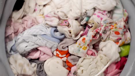 wet spinning baby clothes in washing machine.