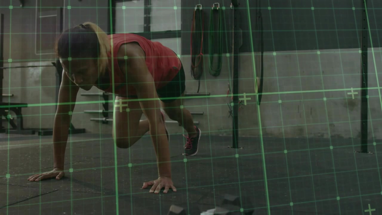 Mid adult woman starting plank, driving alternating knees on mat for fitness, green grid overlay