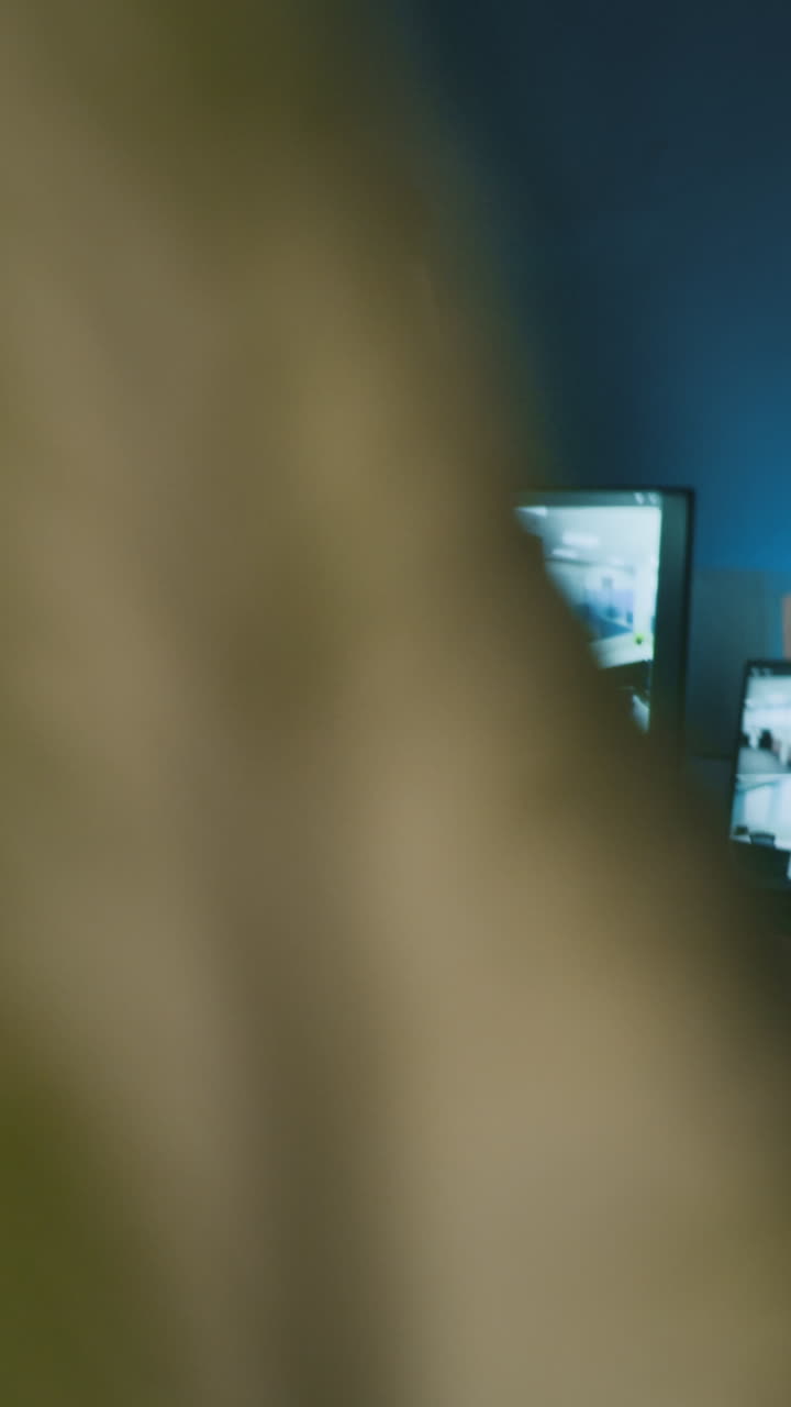Vertical of Manager Using Walkie-talkie in Surveillance Room