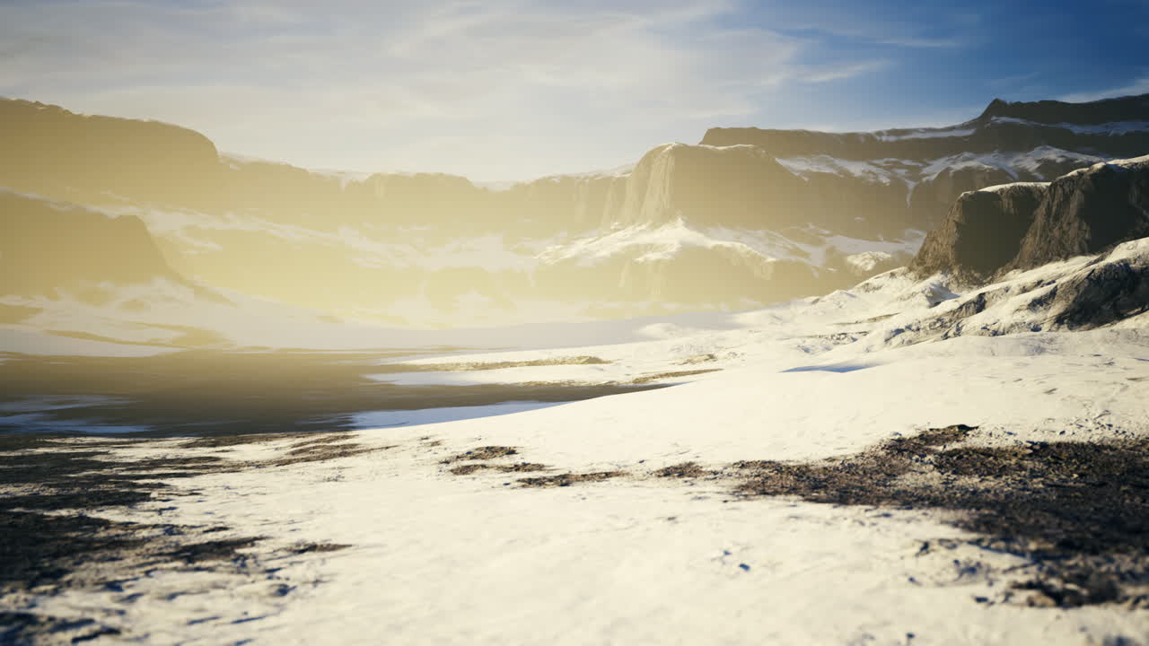 Majestic winter landscape with mountains and frozen terrain at dawn