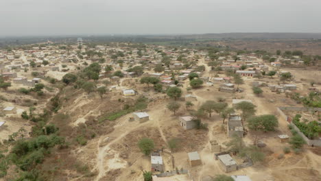 angola, flying over a small adobe village, caxito, bengo, africa