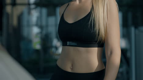 close-up of a fit woman in athletic wear at the gym