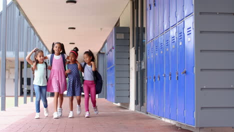 walking together, group of school children chatting near lockers in hallway