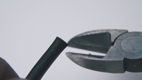 using vintage pliers for cutting wire on light background