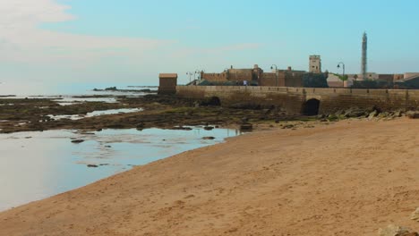 pan shot san sebastian castle on sunny day in cadiz, spain.