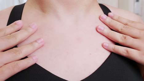 the woman gently caressed her skin in a sports bra