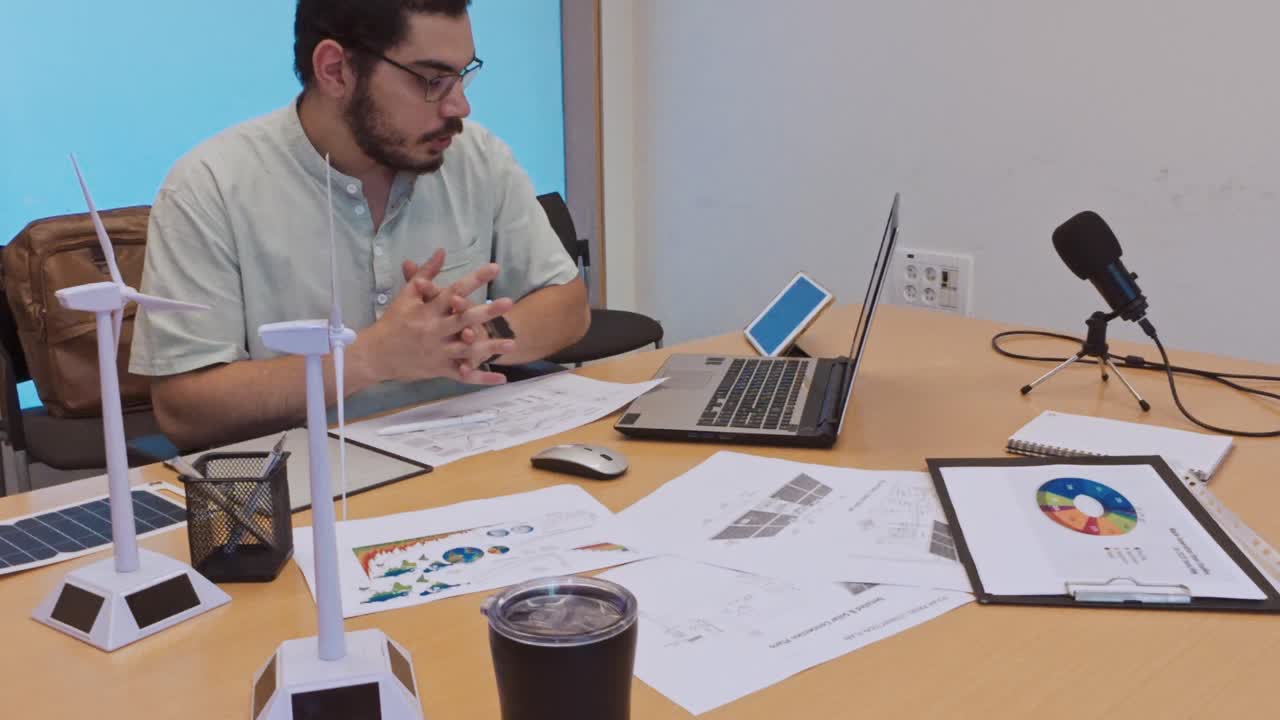Man working on renewable energy project plans in an office