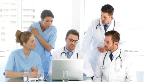 doctor speaking with his staff during a meeting