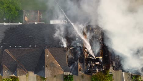 perfect overhead aerial of fire department extinguishing an apartment complex fire