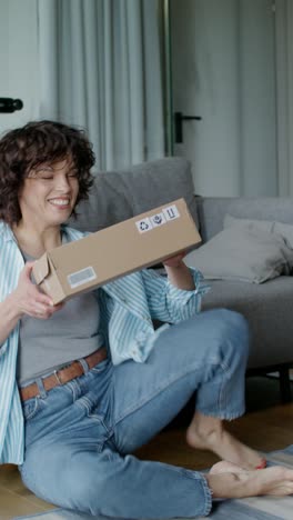 woman excitedly unboxing a package