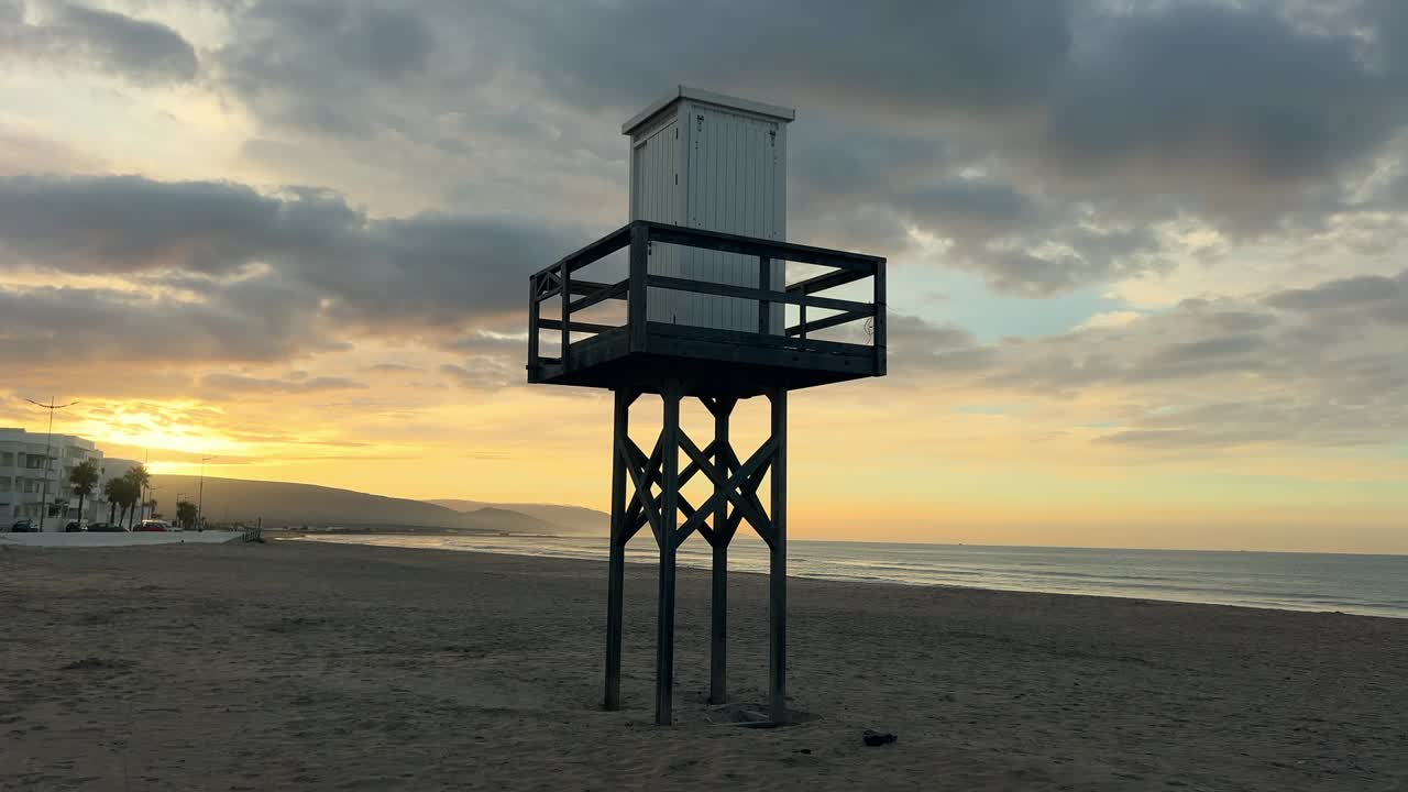 A wide, expansive shot of a pristine beach on a beautiful sunny morning, showcasing clear skies, gentle waves
