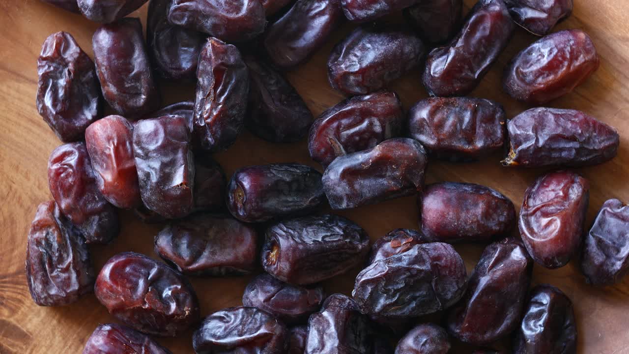 Fresh, tasty dates rotating slowly on a wooden tray