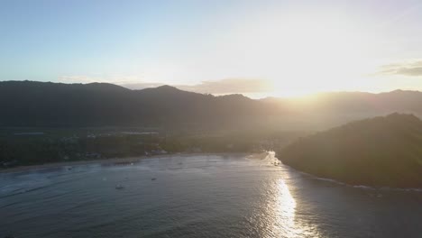 Aerial-backwards-tracking-shot-of-beautiful-sunset-at-Nacpan-Beach-near-El-Nido,-Palawan,-the-Philippines