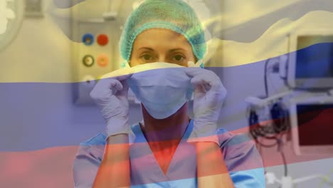 Animation-of-flag-of-colombia-waving-over-anesthesiologist-in-operating-theatre