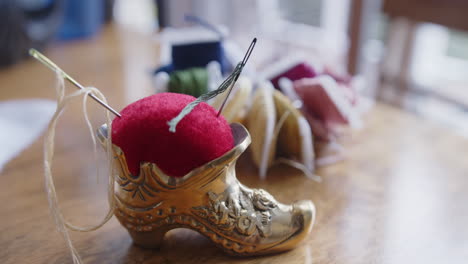 close up of a pin cushion on a table