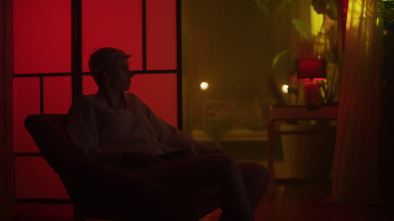 Woman Watching TV in a Cozy Nighttime Living Room