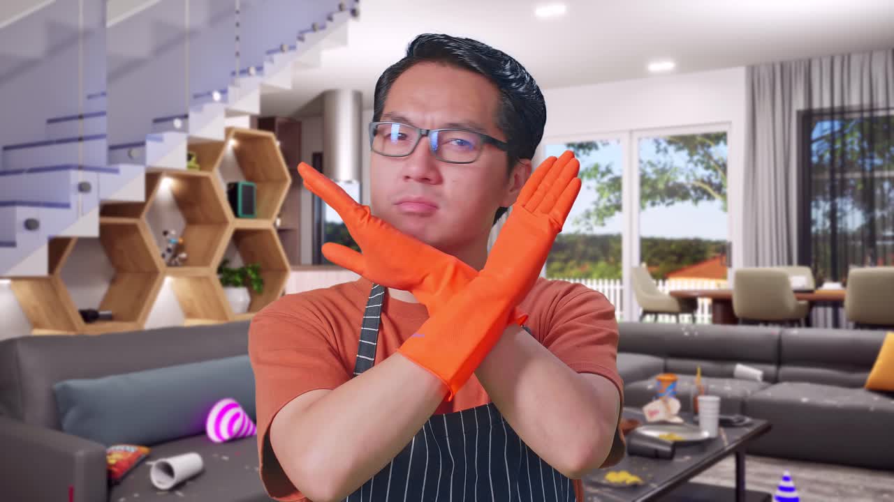 Close Up Of Disagree Asian Male Housekeeper With An Apron Showing Prohibition Action While Standing In House