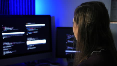 Female-programmer-programming-artificial-intelligence-language-models-using-code-on-multiple-screens
