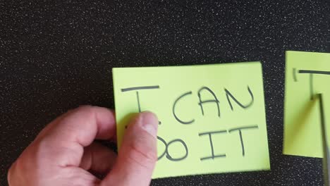 man using scissors to remove the t from the word can't t leaving the positive motivational part. i can do it