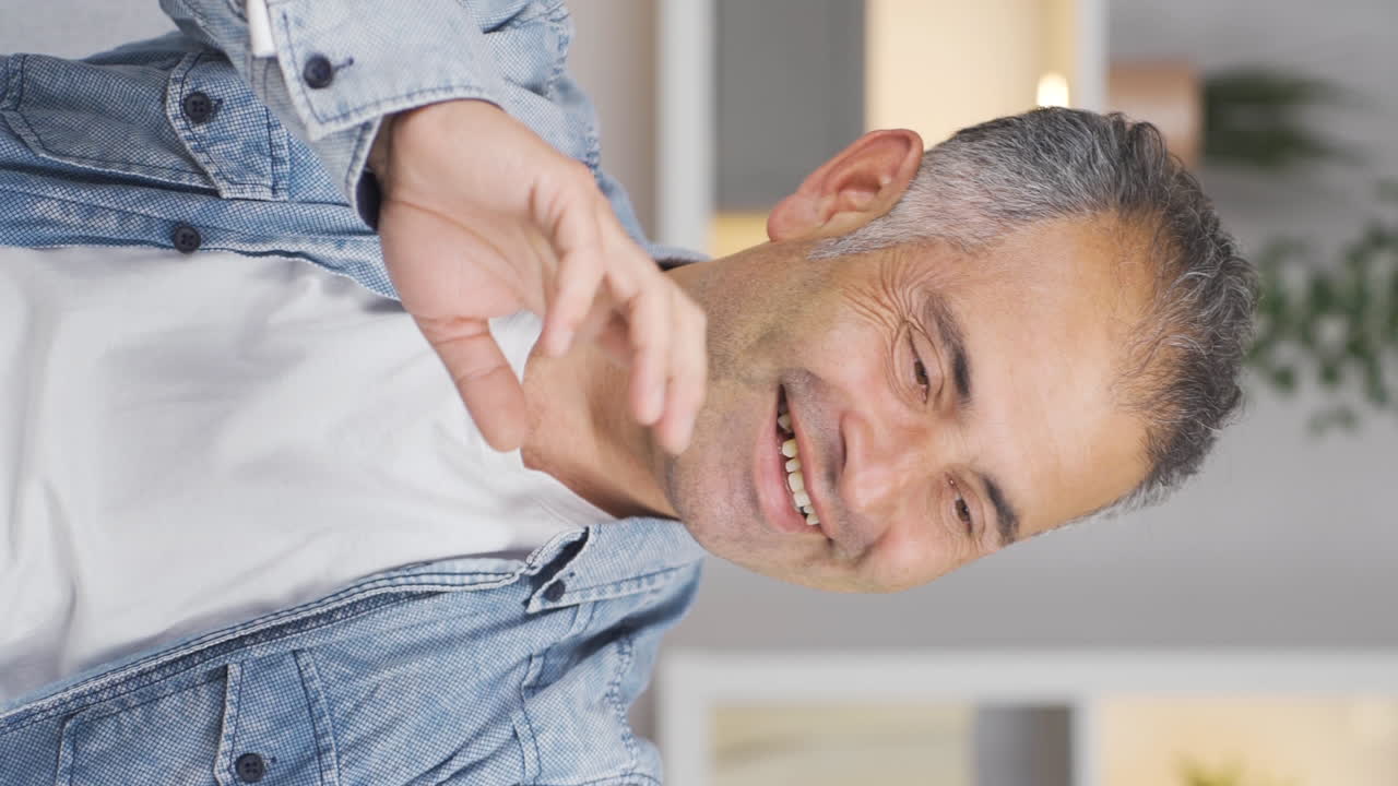 Vertical video of Man making a video call on the phone.