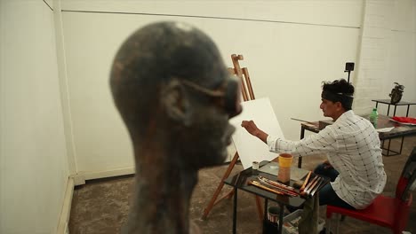 indian artist making a painting in her studio