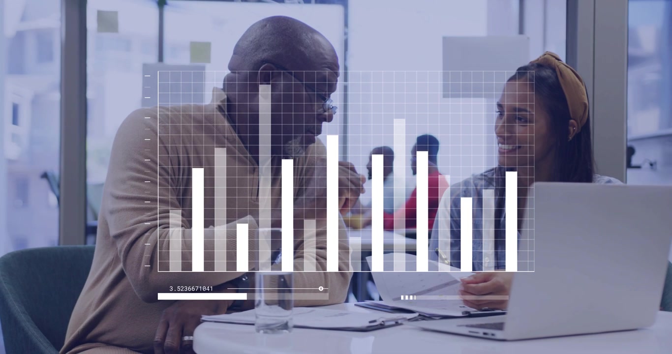 Vertical video: Mentor leaning, chart appearing as pair checking biz data on laptop,papers