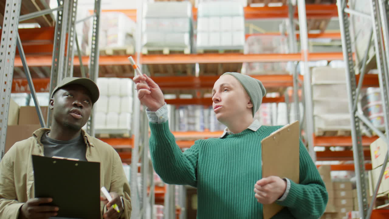Two Warehouse Workers Discussing Inventory and Operations