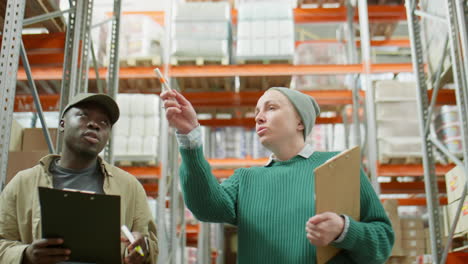 two warehouse workers discussing inventory and operations