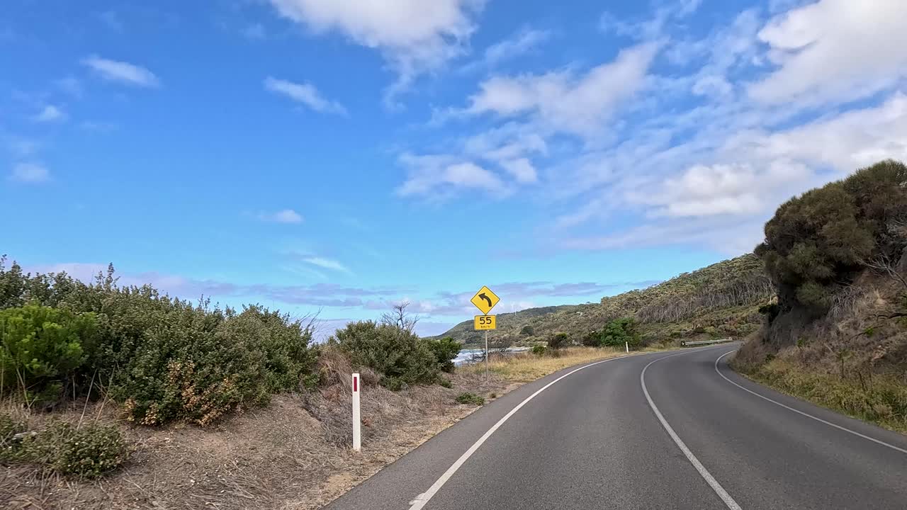 A 30-second drive showcasing coastal views, winding roads, and lush landscapes under a bright blue sky