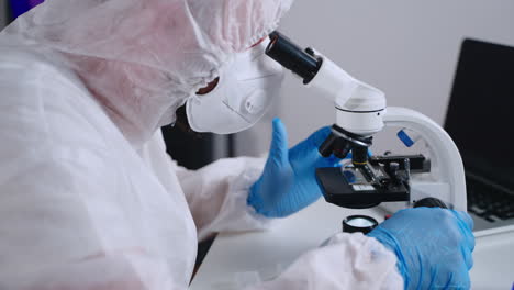 scientist using a microscope in a laboratory setting.