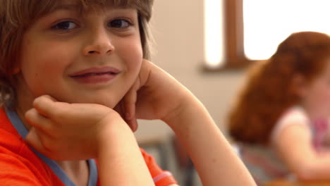 Happy-schoolboy-smiling-at-camera