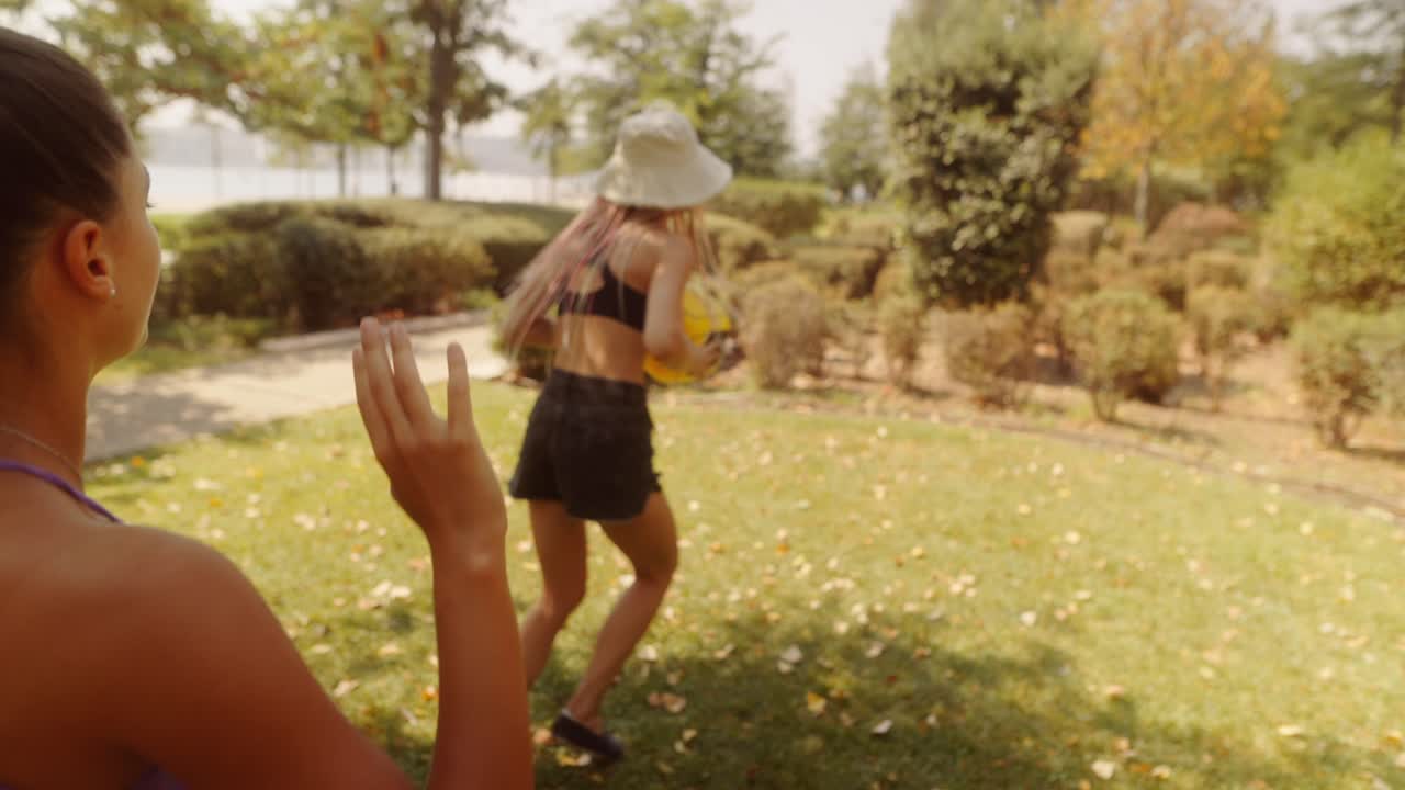 Women Playing Volleyball in Park