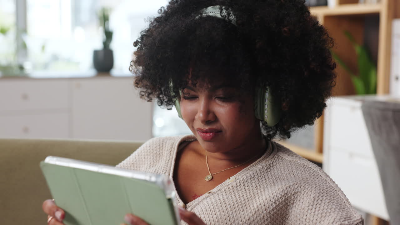 Woman using a tablet with headphones
