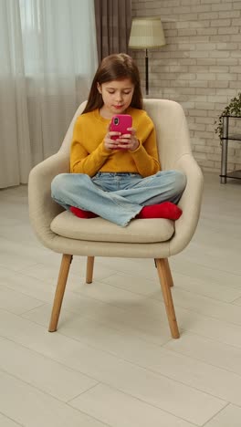 girl using smartphone in a comfortable chair