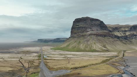 Aerial-View-Of-Road-Number-1-Near-The-Majestic-Lomagnupur-Mountain-In-South-Iceland