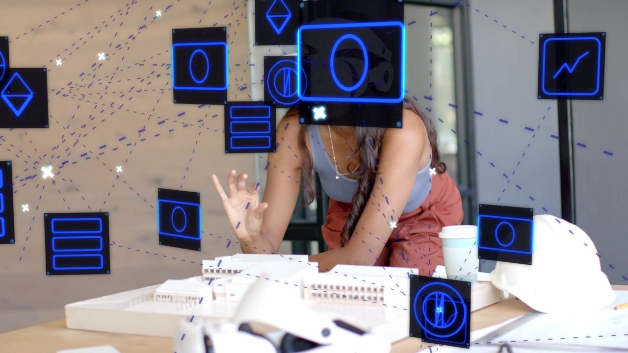 Female architect reaching over table and moving blue AR panels, adjusting headset, reviewing models