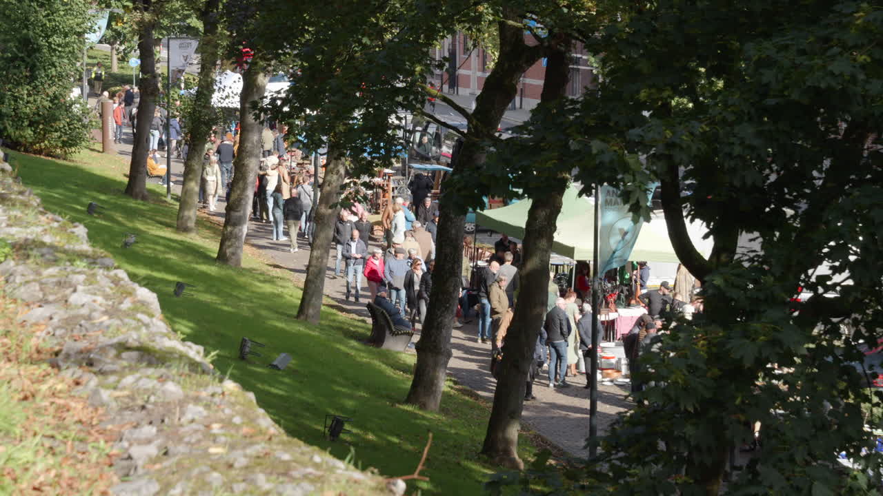 Many People and Tourists Visit the Antiques Market in Tongeren on a Sunny Day