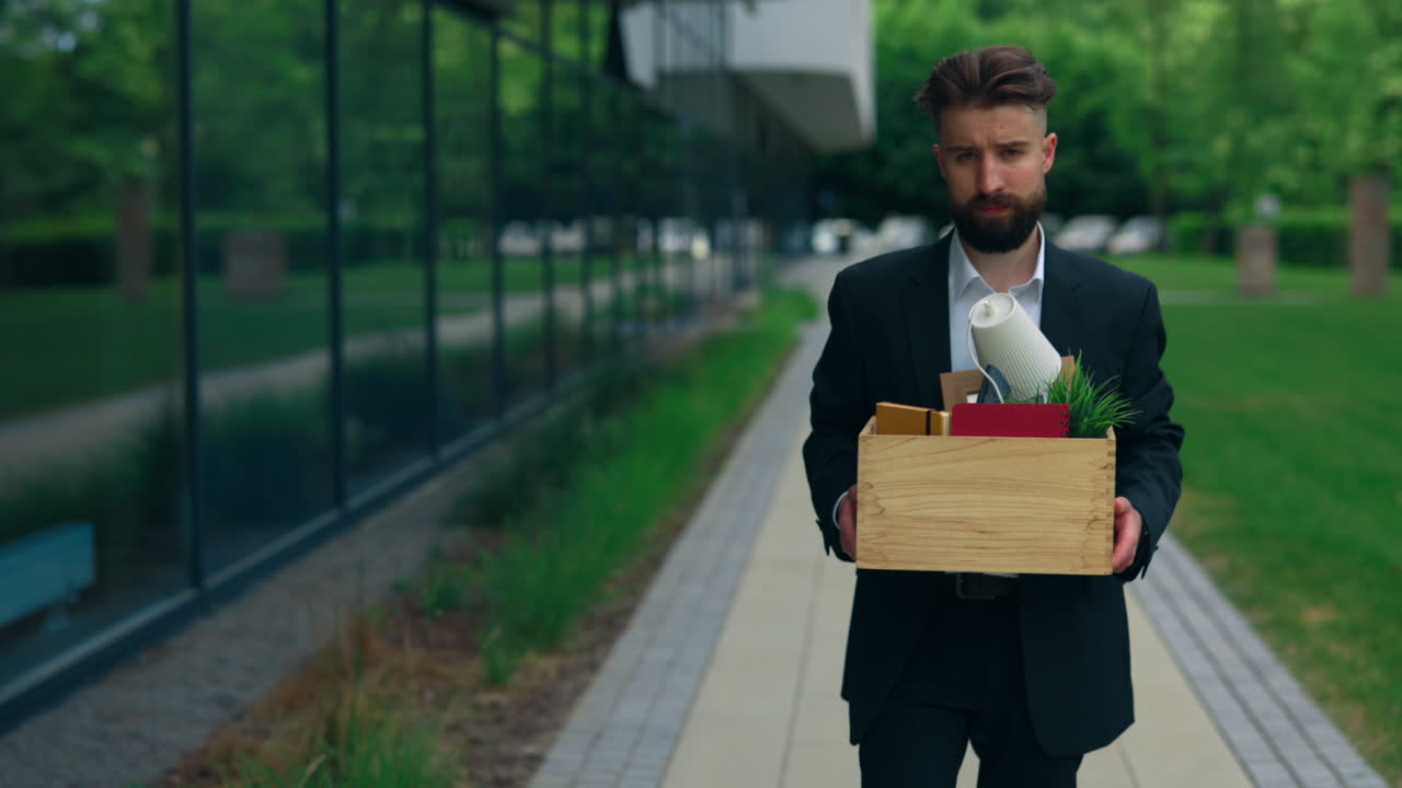 Man Carrying Box Leaving Office