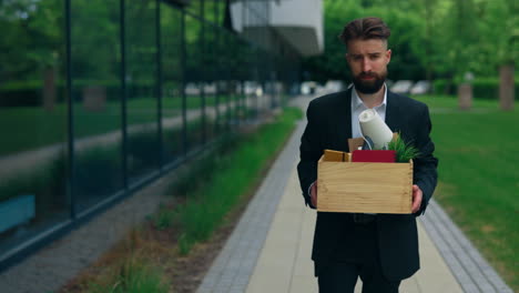 man carrying box leaving office