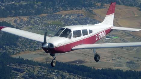 Close-Up-Flying-Small-Airplane-on-a-Sunny-Day,-Air-to-Air-Footage