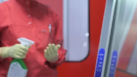 lab worker in orange uniform entering lab, washing hands and begin work